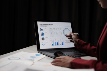 Poster - A woman is using a laptop to draw a graph on a screen