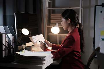 Poster - A woman in a red jacket is sitting at a desk with a computer monitor