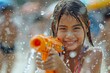 A joyful child plays with a water gun, glistening droplets around her, the epitome of summer fun and childhood glee
