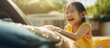 © TheWaterMeloonProjec - A happy little Asian girl is sitting in a car. She appears to be relaxed and content as she sits comfortably inside the vehicle.