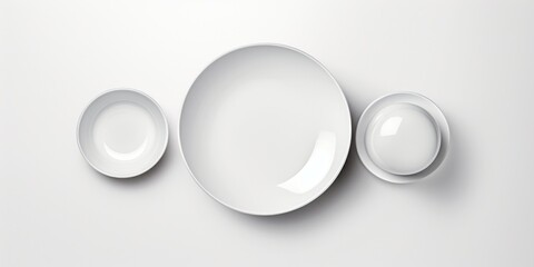 Poster - White plate and two bowls on a table. Suitable for kitchen or dining themes