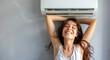 A woman enjoying the cool comfort under the air conditioner, enjoying a home vacation.