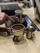 © planeta11 - waiter preparing a coffee with his barista utensils