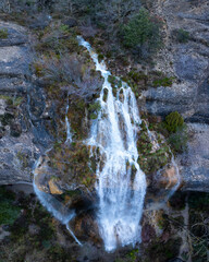 Wall Mural - La Mea waterfall seen from a drone. Between Quintanilla Valdebodres and Puentedey in the area of the Canales del Dulla. The Merindades. Burgos. Castile and Leon. Spain. Europe