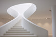 White spiral staircase with a circular opening at the top in a modern building