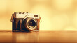 A vintage camera with a brown leather strap on a wooden table with a warm golden background.