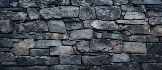 Poster - rugged stone wall texture on dramatic black background - industrial urban design element