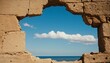 Vintage defunct old brick wall with a round hole overlooking the sea and blue sky. Old abstract architecture, destroyed dam