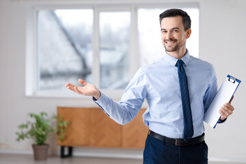 Poster - Portrait of male real estate agent with clipboard showing new apartment