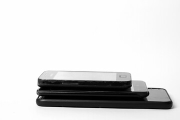 Wall Mural - old mobile phones piled up on a table with white background no people stock image stock photo