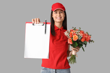 Sticker - Young delivery woman with bouquet of beautiful flowers and clipboard on grey background