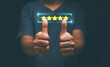 © krungchingpixs - Customer evaluation feedback and satisfaction survey concept, Businessman hands thumbs up for excellence rate, Five stars satisfaction rating, the best rating satisfaction for products and services.