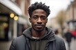Black Man in his 20s or 30s talking head shoulders shot bokeh out of focus background on a cosmopolitan western street vox pop website review or questionnaire candid photo