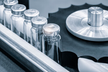 Poster - Pharmaceutical industry. Production line machine conveyor with glass bottles ampoules at factory. Pharmaceutical industry concept background.