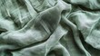 Abstract crumpled linen fabric texture background. Natural pale green color dyed linen organic eco textiles canvas background. Top view