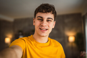 Portrait of young caucasian teen male young man stand at home