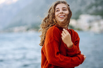 Portrait of a beautiful woman against the background of the sea. Woman and nature.Travel, weekend, relax and lifestyle concept.