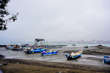 Sticker - Bali, New Taipei, Taiwan, Republic of China, 01 22 2024: Cruise ferry boat and port on Clean Tamsui river in a raining day in winter