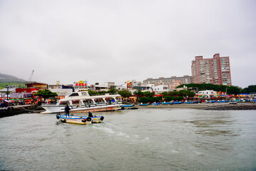 Sticker - Bali, New Taipei, Taiwan, Republic of China, 01 22 2024: Cruise ferry boat and port on Clean Tamsui river in a raining day in winter