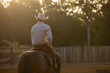Cowboy Horse Trainer on sunny hazy summer morning