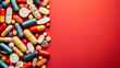 Top view: Various medicines scattered on a red background, illustrating options for different health conditions and needs