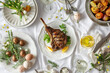 A succulent grilled lamb chop garnished with lemon on a festive table setting with decorative Easter eggs. Grilled Lamb Chop Easter Dinner