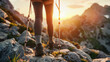 A close-up shot of a hiker's legs using trekking poles on rocky terrain, with the warm glow of sunset in the background