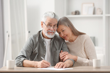 Poster - Senior couple signing Last Will and Testament indoors