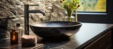 Fototapeta  - black marble round vessel sink and chrome faucet. Minimalist interior of modern bathroom