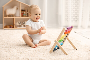 Sticker - Children toys. Cute little boy and wooden abacus on rug at home