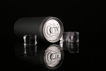 Wall Mural - Energy drink in wet can and ice cubes on black background