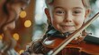charming little girl learning to play the violin with an artistic music teacher  