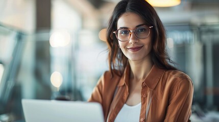 Poster - Successful satisfied and happy businesswoman working inside modern office, Hispanic woman in glasses and shirt using laptop at work, white gray and orange color palette, minimalistic photography, 