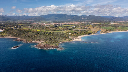 Panorama of the coast of Pula in Sardinia. Crystal clear sea and clouds in the distance