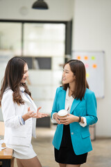 Wall Mural - Asian business woman working and talking at the office
