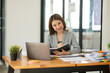 © Thitisak - Asian businesswoman holding notebook about business, spending