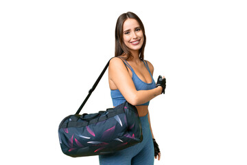 Wall Mural - Young sport woman with sport bag over isolated chroma key background pointing back