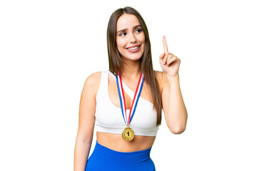 Canvas Print - Young beautiful woman with medals over isolated chroma key background intending to realizes the solution while lifting a finger up