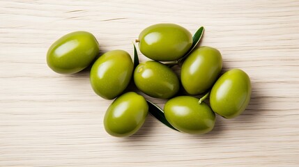 Wall Mural - Delicious large green olives, accompanied by leaves, are isolated on a white background in this aerial view.