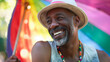 Senior black african american gay man celebrating pride festival with rainbow flags, candid LGBTQ+ summer parade	