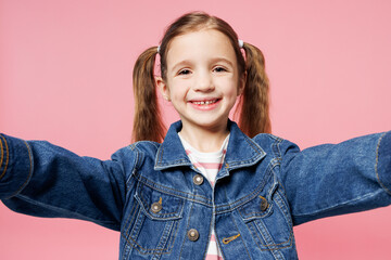 Poster - Close up little child kid girl 7-8 years old wears denim shirt have fun do selfie shot on mobile cell phone isolated on plain pastel light pink background. Mother's Day love family lifestyle concept.