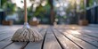 A mop stands on a sun-dappled wooden deck, highlighting outdoor housekeeping and domestic maintenance.