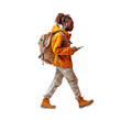 © Ivan Guia - Afro-american male student walking looking at his phone on a cut out PNG transparent background