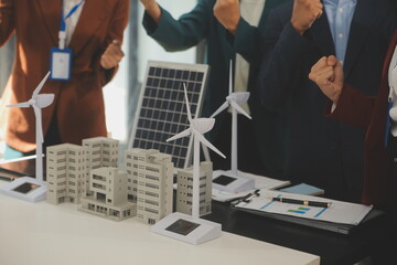 Wall Mural - Close-up at tablet, Engineers pointing at tablet with their hands. To jointly design the use of renewable energy with wind and solar energy. Concept of using renewable energy.