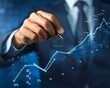 © arhendrix - Businessman drawing a growth graph on a blue background