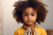 Portrait of a cute little girl with big eyes and beautiful curly hair