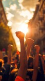 Fototapeta Panele - labor day concept, group of protesters with fists raised for justice and freedom in a peaceful urban demonstration at sunset