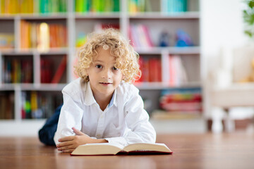 Wall Mural - Child reading book. Kids read. School education.