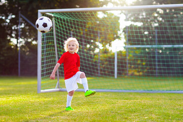 Canvas Print - Kids play football. Child at soccer field.