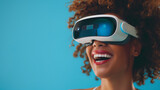 Fototapeta  - Close-up of young laughing enthusiastic woman wearing white augmented virtual reality glasses on studio blue background with copy space